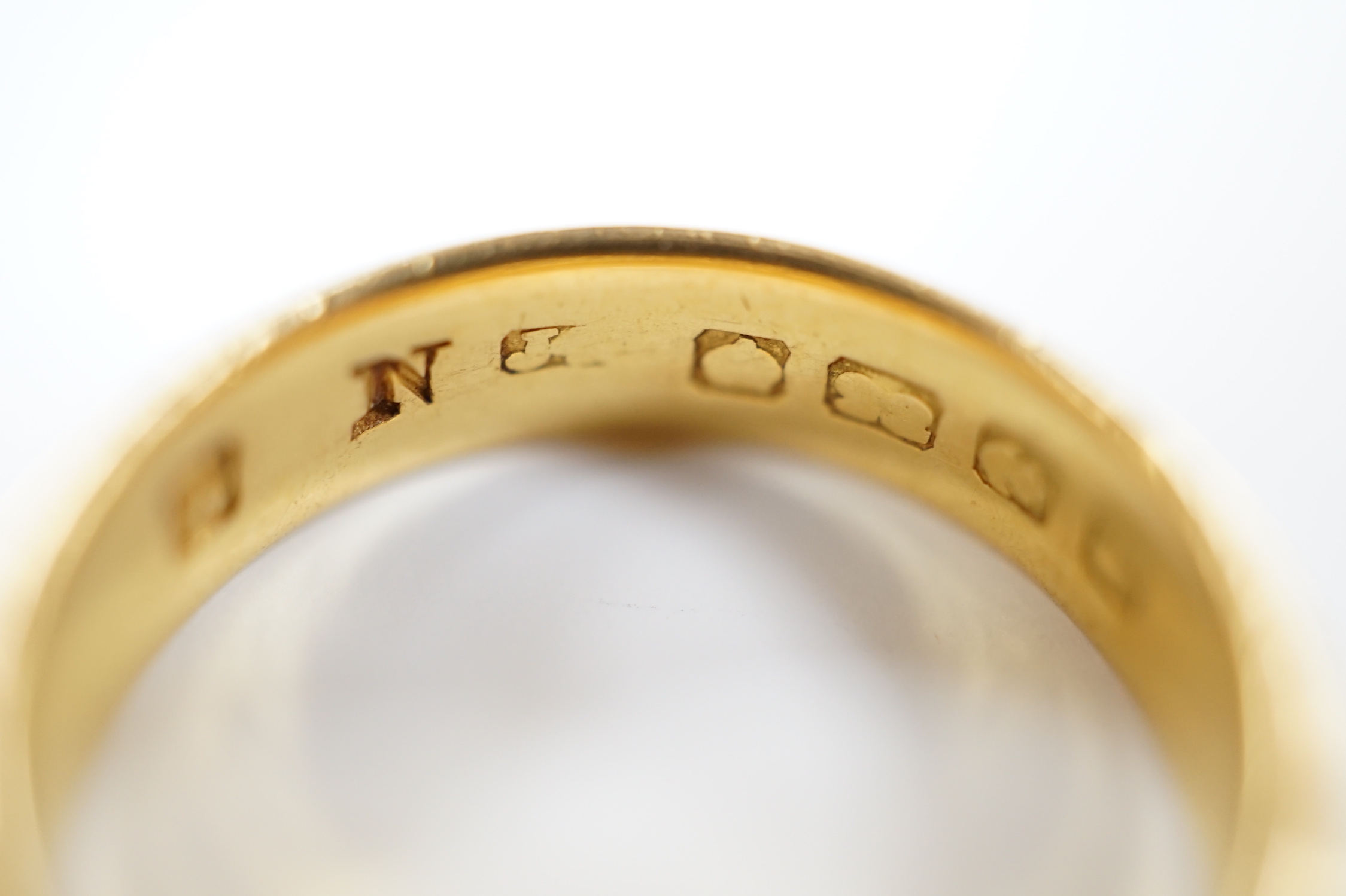 A 22ct. gold wedding band, size N, 7.2 grams.